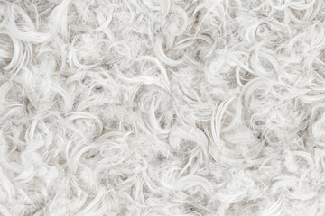 White feathers and fluff from pillows texture background