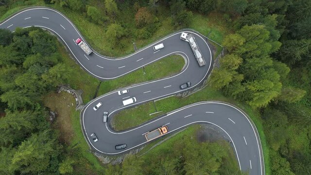 Winding road with hairpins and traffic at Maloja pass, Switzerland