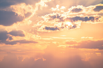 Golden sunset sky with dramatic clouds and sun rays