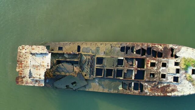 Drone flight over the abandoned crashed ship in the sea,Top view Aerial view of shipwreck