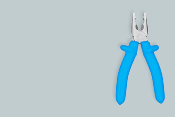 Metal pliers with rubber grips Background on the theme of tools, repair or maintenance of equipment.