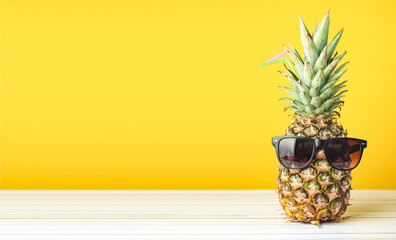 Pineapple with glasses summer on yellow background © Exploder