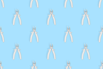 Pliers seamless pattern. Metal pliers with rubber grips.