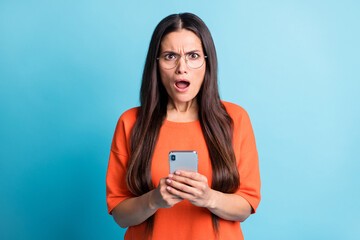 Photo of impressed woman open mouth angry staring unexpected bad fake news isolated on blue color...