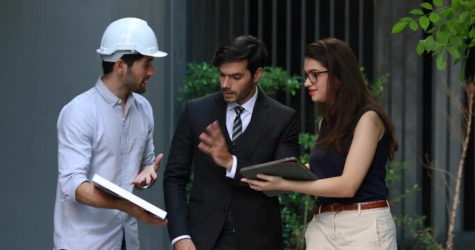 Young Executive CEO business man and woman secretary meeting with energy engineer plan a project to build a solar panel for the building under construction.