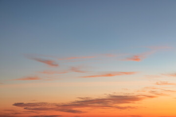 Obraz premium Heaven at early morning with copy space. Sunset, sunrise backdrop.Predawn clear sky with orange horizon and blue atmosphere. Smooth orange blue gradient of dawn sky.