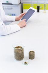Scientist’s hands working with tablet in cbd laboratory