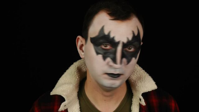 Portrait of man in demon makeup doing no gesture while looking at the camera