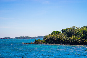 Hon Thom island in Phu Quoc, Vietnam, Asia - Tropical view with colorful houses, blue waves and blue sky, fishing boats and far away is a longest cable car