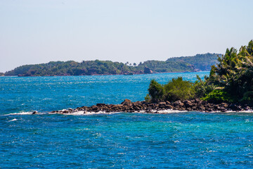 Hon Thom island in Phu Quoc, Vietnam, Asia - Tropical view with colorful houses, blue waves and blue sky, fishing boats and far away is a longest cable car