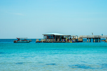 Beautiful landscape of Hon Thom beach, Phu Quoc island, Vietnam, Asia with tourist, chairs and umbrella. White sand and coco palms travel tourism and swing under tree.