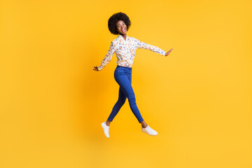 Fototapeta na wymiar Full length photo of pretty charming dark skin lady dressed casual outfit jumping high isolated yellow color background