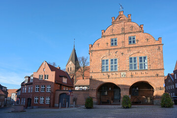 Market place in the city of Gadebusch with the medieval town hall and church in red brick...