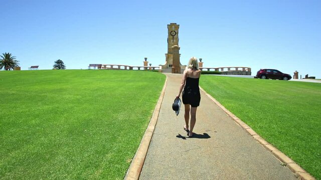 Tourist woman on the Walkway to Fremantle War Memorial at Monument Hill overlooks Fremantle Harbor in Perth, Western Australia. The memorial commemorates World War I.