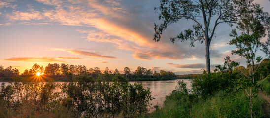 Beautiful Panoramic Riverside Sunset with Reflections