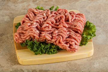 Raw pork minced meat over board