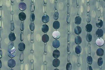 Hanging silver metal drops. Abstract background.
