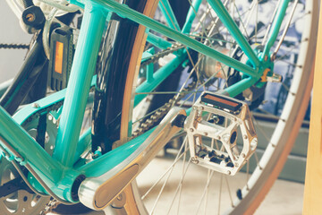 Vintage Bicycle part of bike cycle wheel interior Design with people lifestyle hobby in a modern city. Bicycle with sunlight background and loft decorating style focus on bike wheel