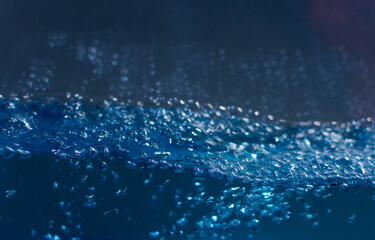 Abstract background with fresh clear blue water. Closeup. Selective focus.