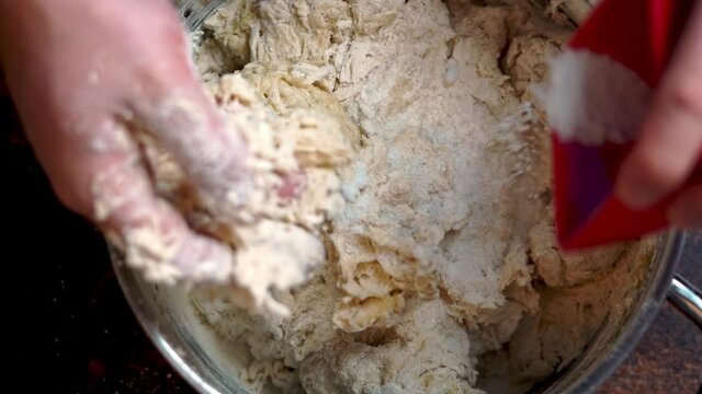 Italian Pizza Dough. the cook adds salt to the flour. DIY homemade dought concept.
