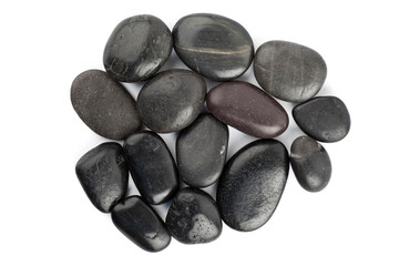 A group of black stones. Studio photo isolated on white background.