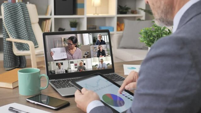 business people talking in video call conference using computer app,back view of a man sharing sale report to group of colleagues during an online meeting on laptop screen,remote working from home