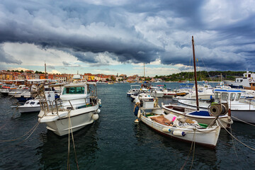 Fototapeta na wymiar fishing boats moored at the pier in harbour of Rovinj town, Croatia.