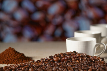 A Cup of coffee on the marble table. Coffee beans on the table, blurred background. Close-up