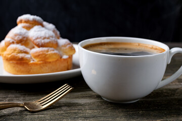 cup of coffee and cake on wooden table