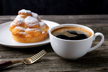 cup of coffee and cake on wooden table