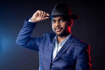 Indian young businessman on dark background