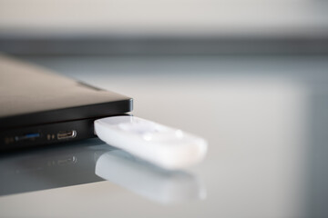 Closeup of white pendrive connected to USB port