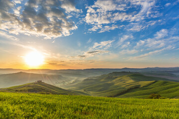 Sunrise in Tuscan with rolling rural landscape in mist