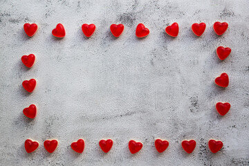 Heart-shaped Valentines candies on gray background