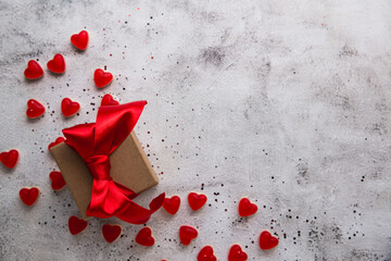 Valentine's Day, Gift box with a ribbon and heart shaped candy.