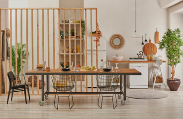Dining room and working table in front of the decorative kitchen style, refrigerator, dishwasher and sink decorative style.