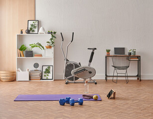 Training at home concept, interior, decorative sport in the room with gym fitness exercise purple mat, dumbbell and bicycle.