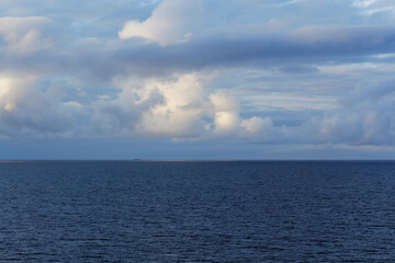 Naklejka na ściany i meble Beautiful landscape with blue sea and clouds above the horizon
