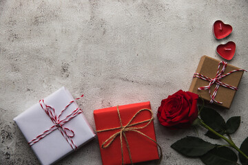 Valentine's Day, Gift box with a ribbon, candles and rose. - 405449441