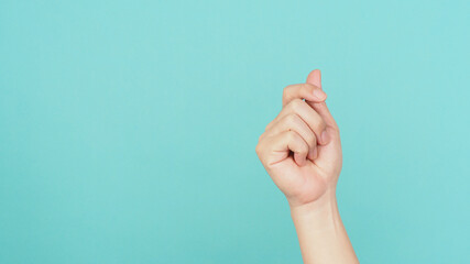 Empty Hand holding nothing guesture on green and blue or mint background.