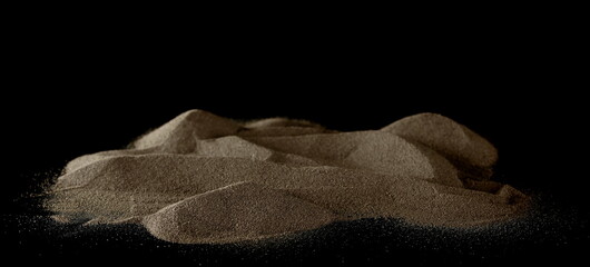 Beach, desert sand pile isolated on black background