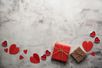 Valentine's Day, Gift box with a ribbon, candles and paper hearts. - 405450225