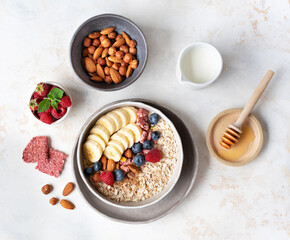 Healthy diet. Oatmeal. Ingredients for porridge. Wholesome breakfast. Delicious summer berries. Useful nuts.