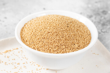 Amaranth. Amaranth seeds in a white bowl on a light gray kitchen table