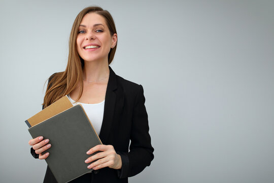 Smiling woman teacher or student with positive emotion holding book and work book.
