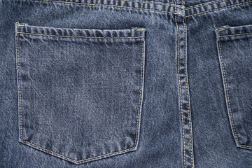 Classic jeans background. Denim textured fabric with a trendy design seam. Selective focus