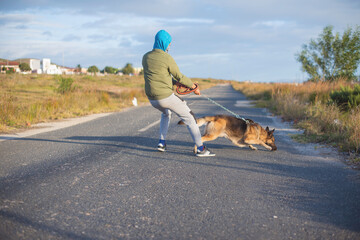 image of a dog strongly pulling against a leash