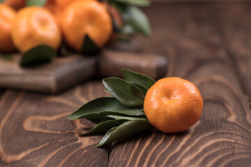 The spin of the tangerine close-up on brown wooden background. Ripe fruit.