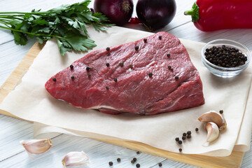 Raw meat beef on cutting board with spices