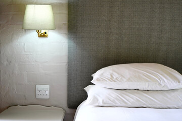 Hotel room bed and bedside lamp